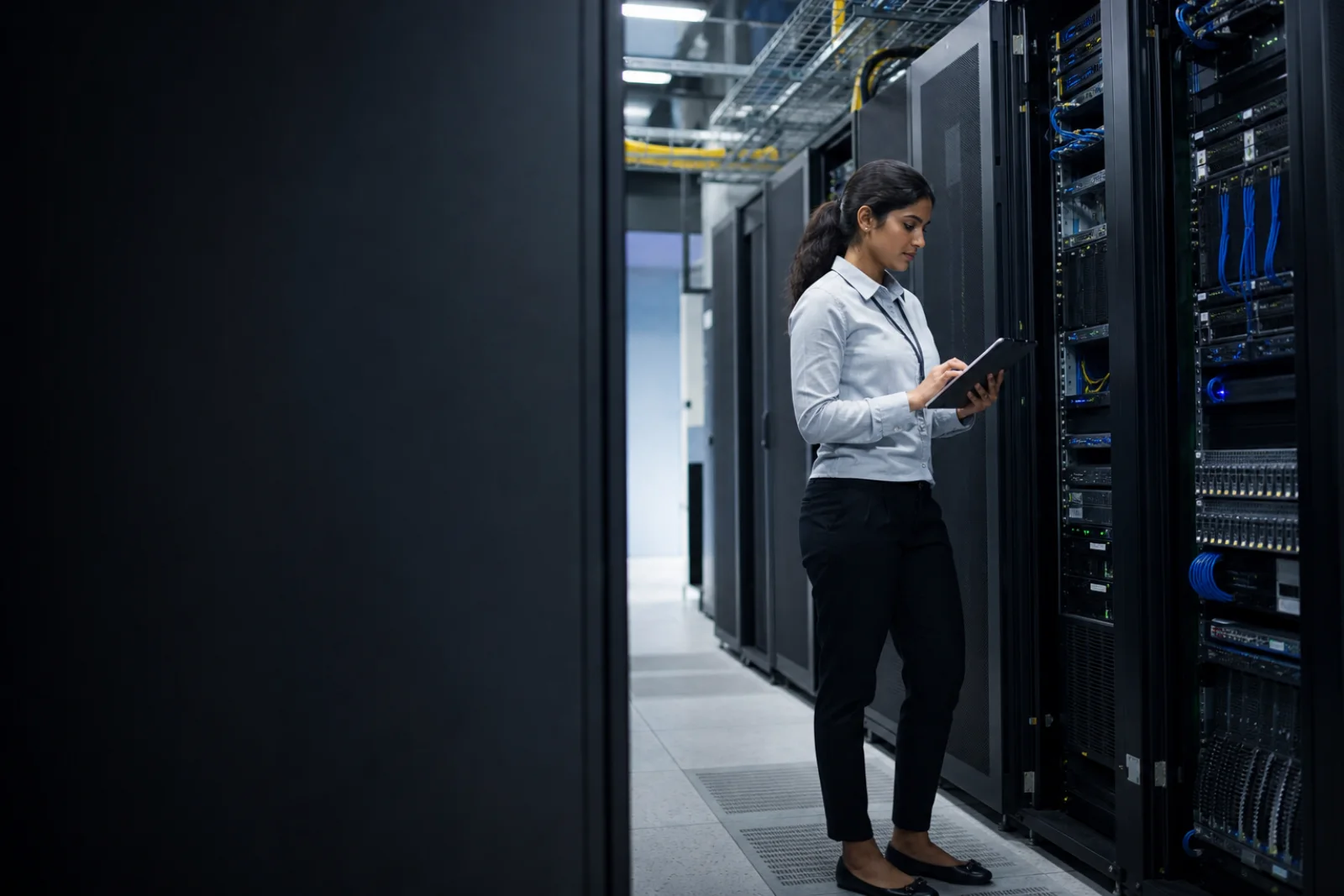 Server engineer reviewing managed infrastructure in a modern data center
