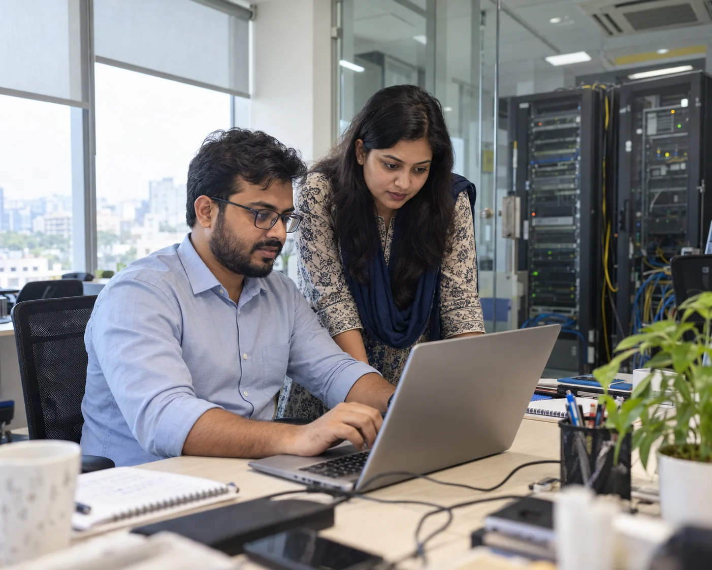 Bangladeshi business team reviewing website hosting in a real office